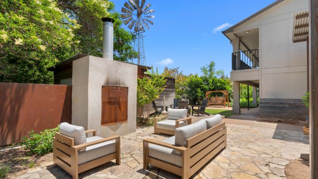 An outdoor patio area with furniture and a BBQ grill
