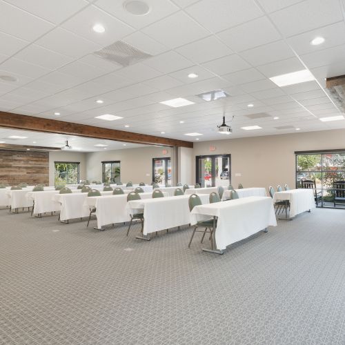 A bright, modern showroom with white walls, display islands, and product samples arranged in an open, airy space.